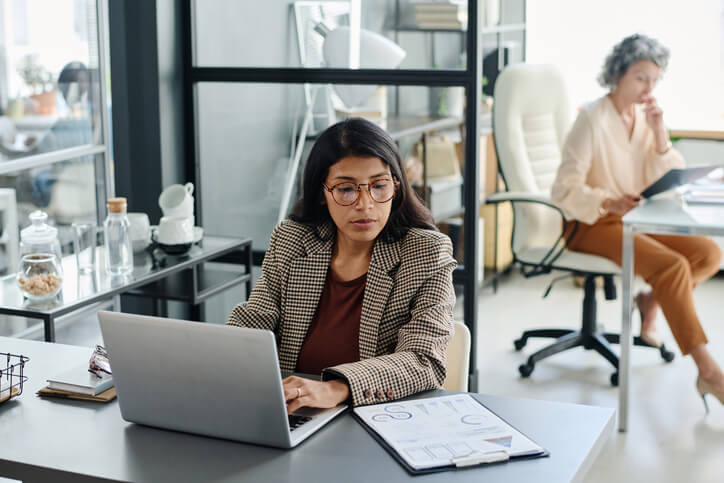 A payroll professional entering data in an office setting