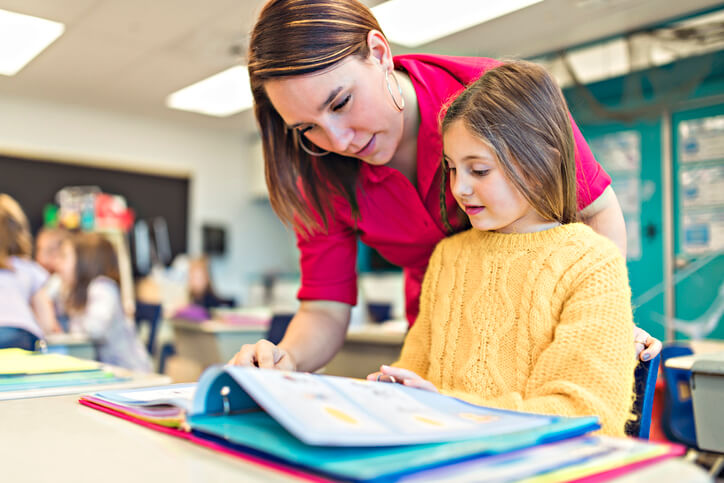 An educational Assistant assisting a student with learning needs in a BC classroom