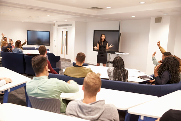 An auditorium of college students enrolled in a career training program listening to a lecture